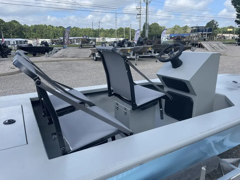Slide: The Image of The image shows a gray micro-skiff boat with two seats and a steering console. - 6