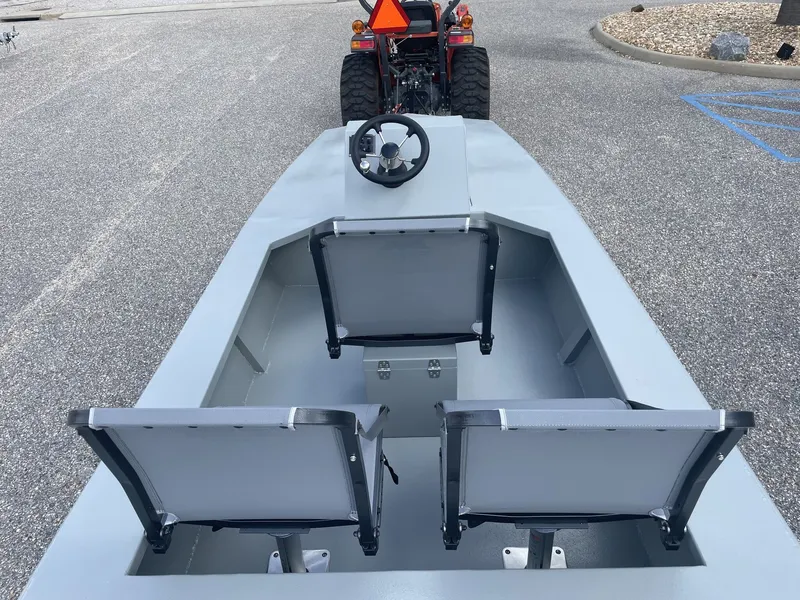 Slide: The Image of The image shows a gray micro-skiff boat with two seats and a steering wheel. - 5