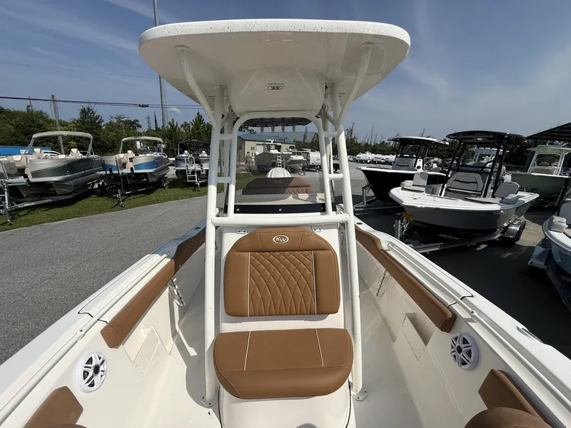 Slide: The Image of The image shows a Key West 239 FS boat with brown seats and a shaded canopy. - 3