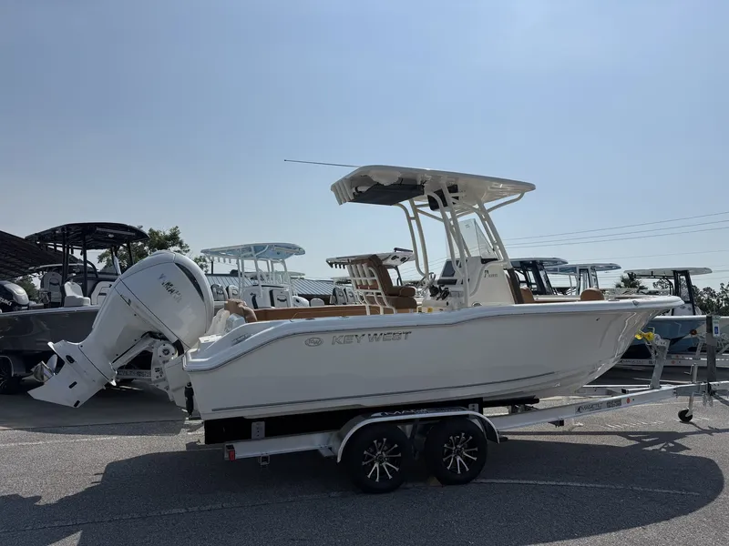 Slide: The Image of A 2027 Key West 239 FS boat is on a trailer in an outdoor area. - 2