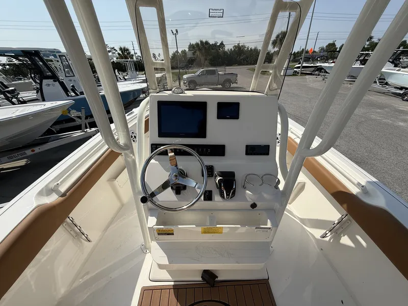 Slide: The Image of The image shows the helm of a Key West 239 FS boat with modern instruments. - 12