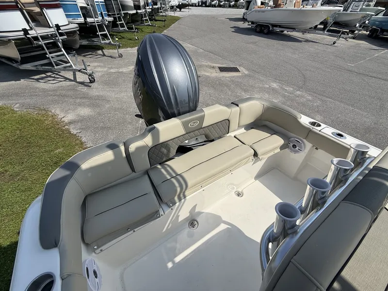 Slide: The Image of The image shows the cockpit of a Key West 203 FS boat with beige upholstery and rod holders. - 15