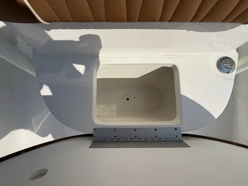 Slide: The Image of A white boat with a built-in compartment and brown upholstery. - 8