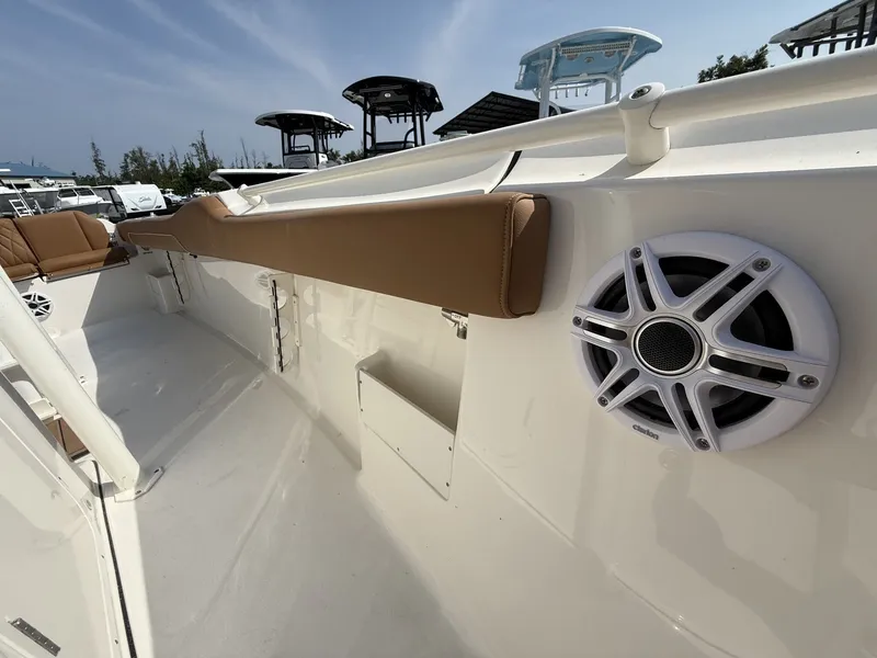 Slide: The Image of The image shows the deck of a Key West 239 FS boat with speakers and padding. - 9