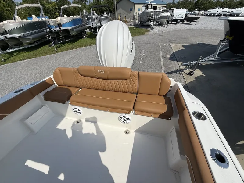 Slide: The Image of The image shows the stern of a Key West 239 FS boat with brown upholstery and speakers. - 14
