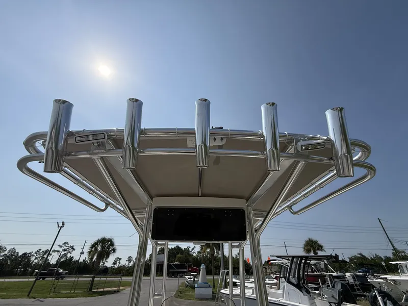 Slide: The Image of A Key West 203 FS boat with a sturdy T-top and multiple fishing rod holders. - 16