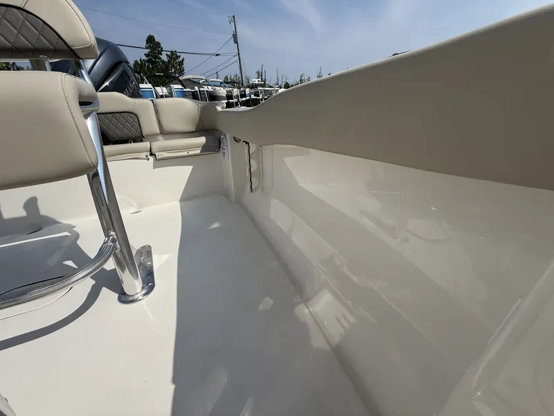 Slide: The Image of The image shows the interior of a Key West 203 FS boat with beige seats and a glossy floor. - 9