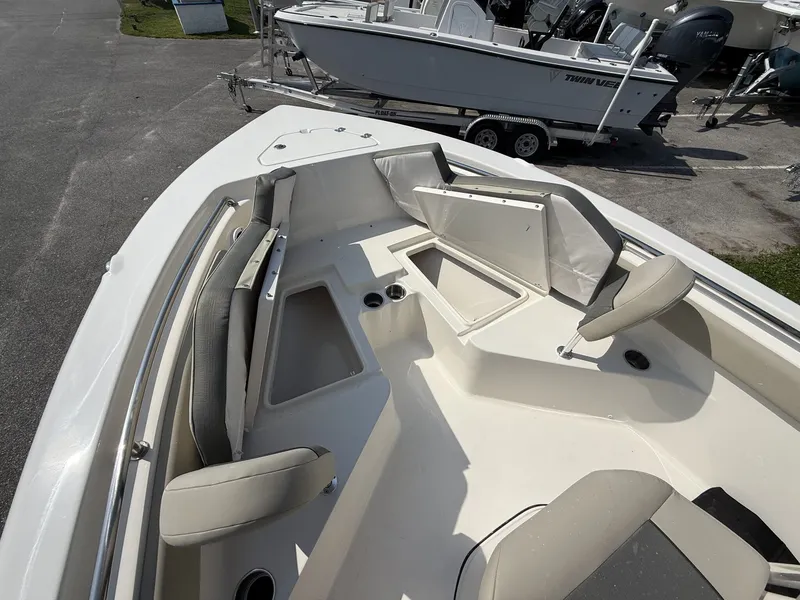 Slide: The Image of The image shows the deck of a Key West 203 FS boat with seating and storage compartments. - 4