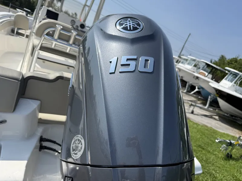 Slide: The Image of A gray outboard motor labeled "150" is mounted on a boat. - 6