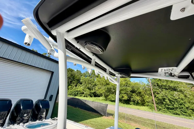 Slide: The Image of 2013 Nor-Tech 392 Super Fish boat with T-top and rod holders, parked outdoors. - 23