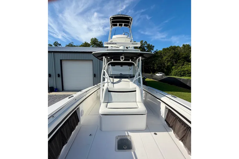 Slide: The Image of 2013 Nor-Tech 392 Super Fish boat with Garmin equipment, docked near a metal building. - 27