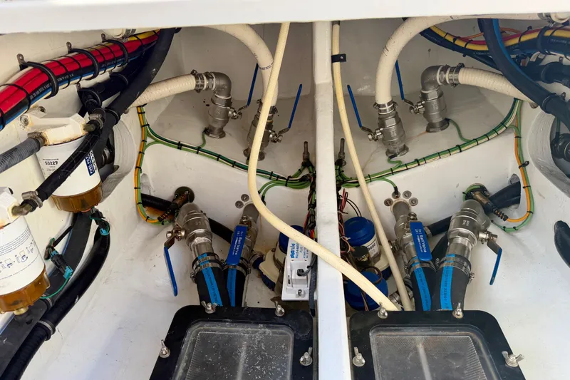 Slide: The Image of Engine compartment of a 2013 Nor-Tech 392 Super Fish, showcasing hoses and fittings. - 13