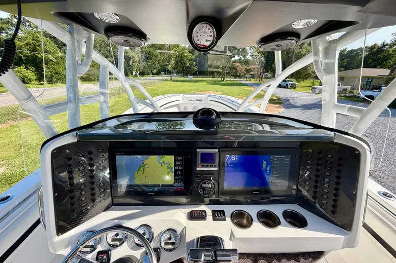 Slide: The Image of Cockpit view of 2013 Nor-Tech 392 Super Fish boat with advanced navigation displays. - 17