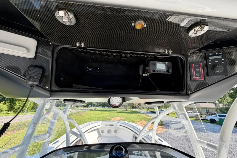 Slide: The Image of 2013 Nor-Tech 392 Super Fish boat dashboard with advanced navigation and communication equipment. - 19