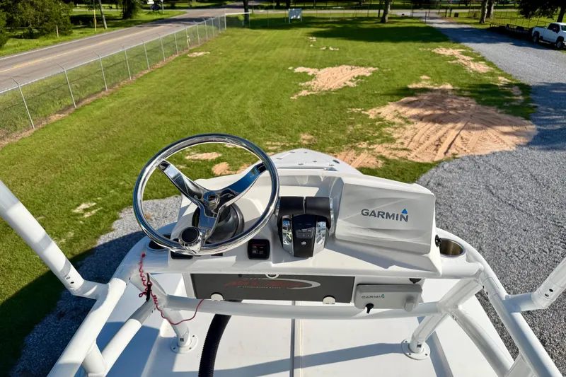 Slide: The Image of 2013 Nor-Tech 392 Super Fish helm with Garmin navigation system, overlooking grassy area. - 39