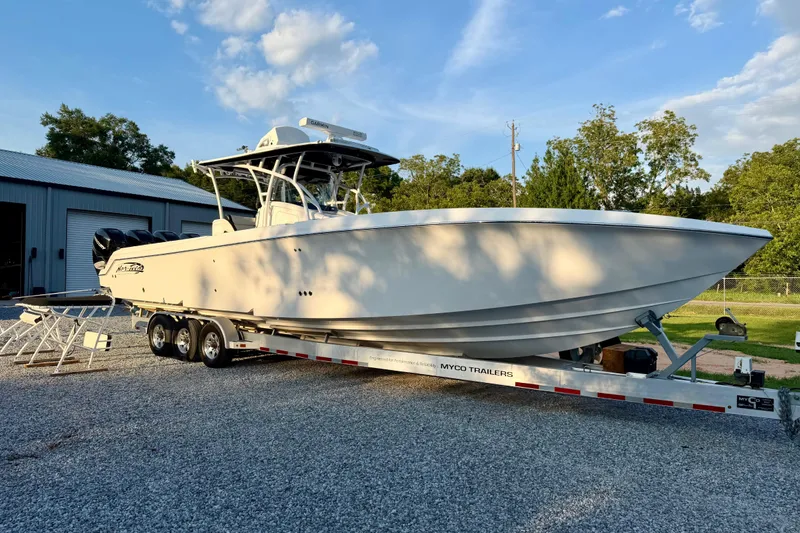 Slide: The Image of 2013 Nor-Tech 392 Super Fish boat on trailer, parked outdoors under blue sky. - 45