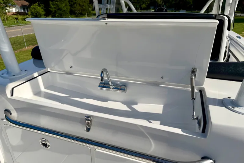 Slide: The Image of Open storage compartment with faucet on 2013 Nor-Tech 392 Super Fish boat. - 9