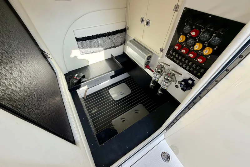 Slide: The Image of Interior view of 2013 Nor-Tech 392 Super Fish boat, featuring control panel and storage area. - 36