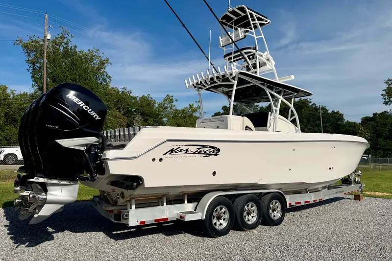 Slide: The Image of 2013 Nor-Tech 392 Super Fish boat on trailer with Mercury engines, parked outdoors. - 3