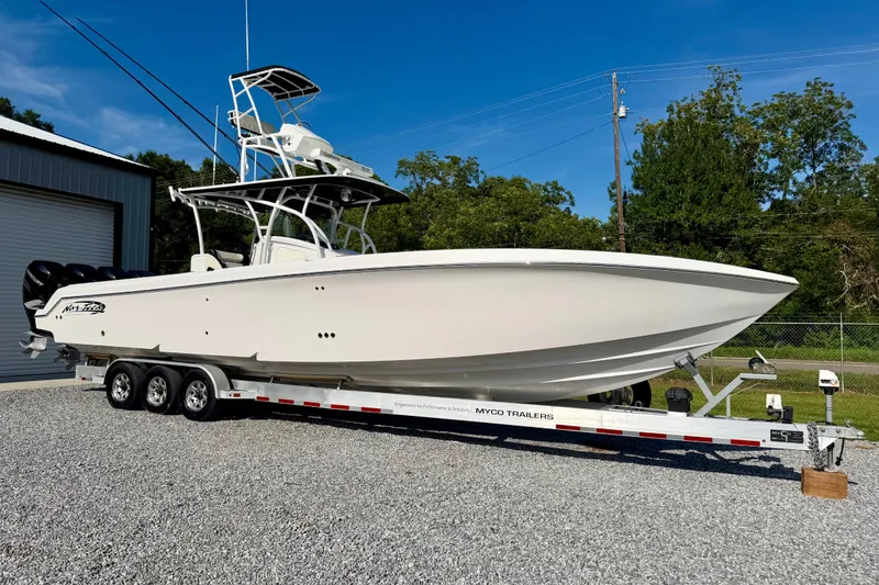 The Image of 2013 Nor-Tech 392 Super Fish boat on trailer, parked outdoors under clear blue sky. - 1