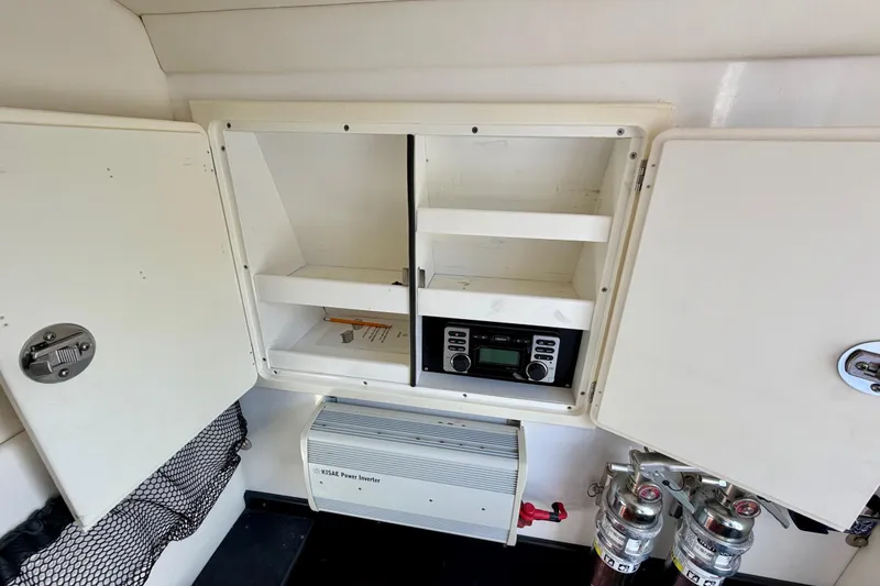 Slide: The Image of Interior of 2013 Nor-Tech 392 Super Fish boat with storage, power inverter, and control panel. - 35