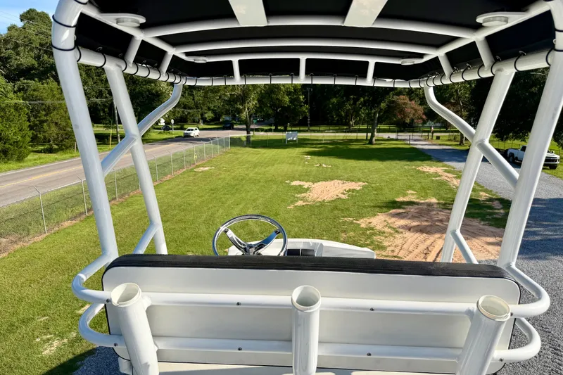 Slide: The Image of View from the helm of a 2013 Nor-Tech 392 Super Fish boat, overlooking grassy area. - 38