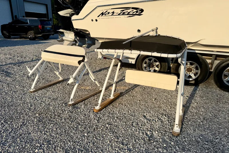 Slide: The Image of 2013 Nor-Tech 392 Super Fish boat on trailer with fishing equipment nearby. - 46