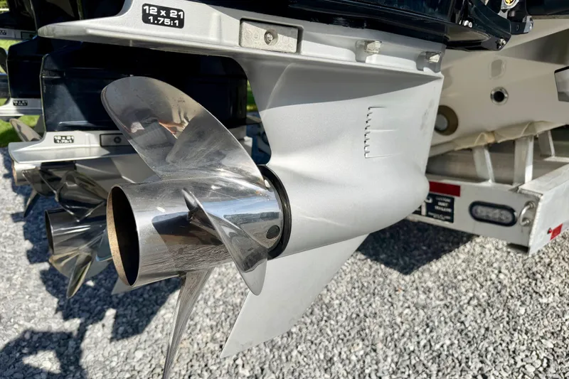 Slide: The Image of Close-up of a 2013 Nor-Tech 392 Super Fish boat propeller on a gravel surface. - 5