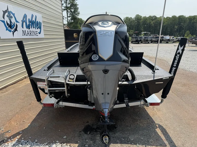 Slide: The Image of The image shows a 2027 Xpress Hyper-Lift Bay Series H24B boat with a powerful outboard motor. - 9