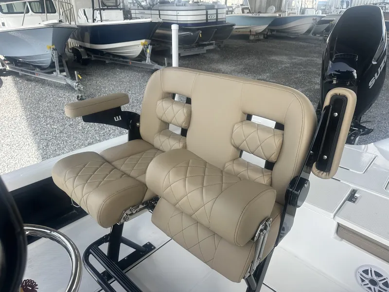 Slide: The Image of A luxurious, padded double seat in a modern boat, surrounded by other boats in the background. - 12