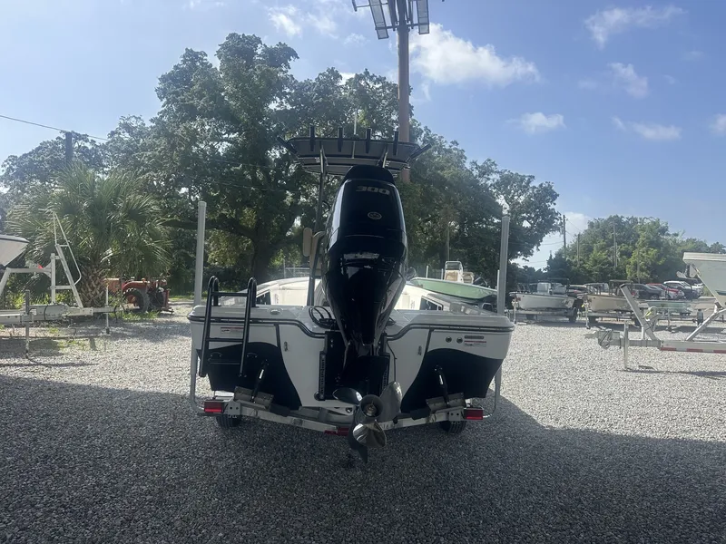 Slide: The Image of A 2026 Blazer PureBay 2400 on a gravel lot. A powerful outboard motor is visible. - 9