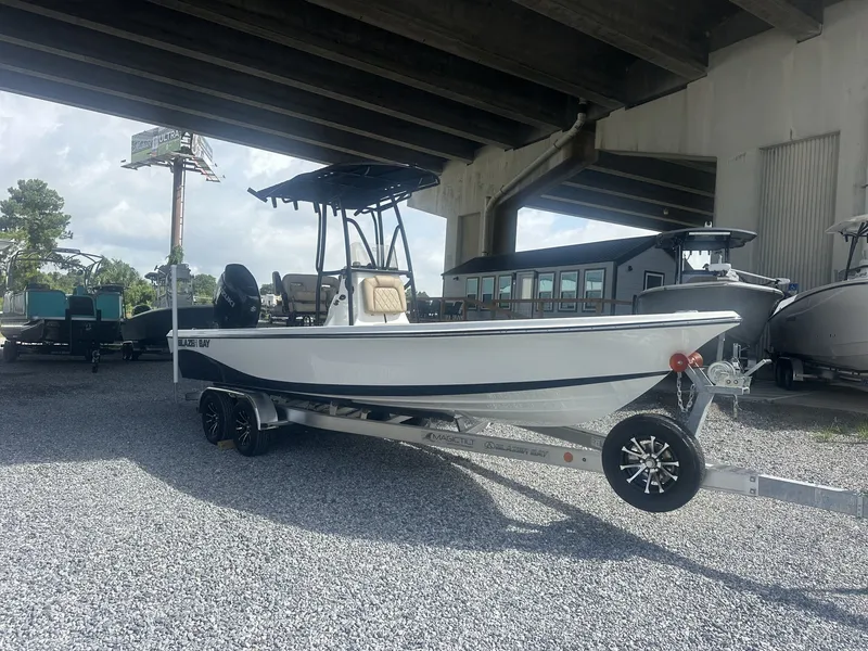 Slide: The Image of A 2026 Blazer PureBay 2400 sits on a trailer under a bridge. - 2