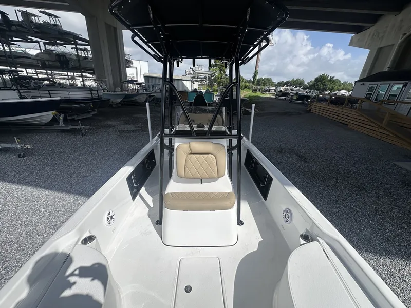 Slide: The Image of The image shows the cockpit of a 2026 Blazer PureBay 2400 boat. It features a cushioned seat and a black T-top. - 7