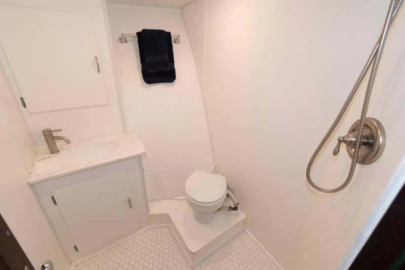 Slide: The Image of Bathroom interior of 1970 Hatteras 45 Convertible yacht, featuring shower, toilet, and sink. - 20