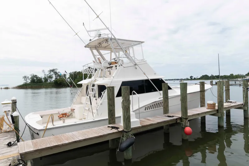 The Image of 1970 Hatteras 45 Convertible yacht docked at a serene marina. - 0