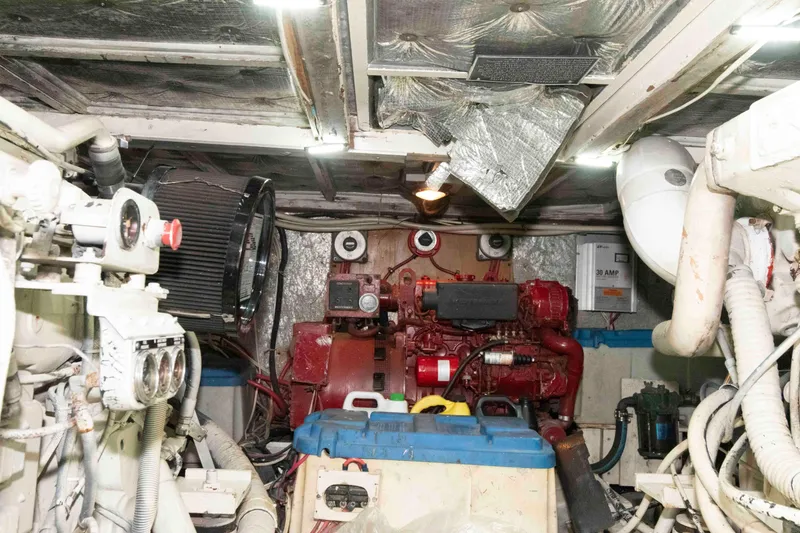 Slide: The Image of Engine room of a 1970 Hatteras 45 Convertible boat, showcasing machinery and equipment. - 24