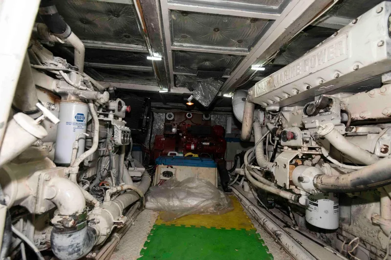 Slide: The Image of Engine room of a 1970 Hatteras 45 Convertible yacht, showcasing mechanical components. - 21