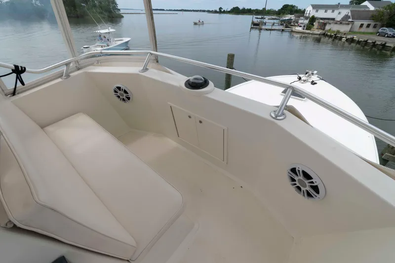 Slide: The Image of 1970 Hatteras 45 Convertible boat interior with cushioned seating and water view. - 10