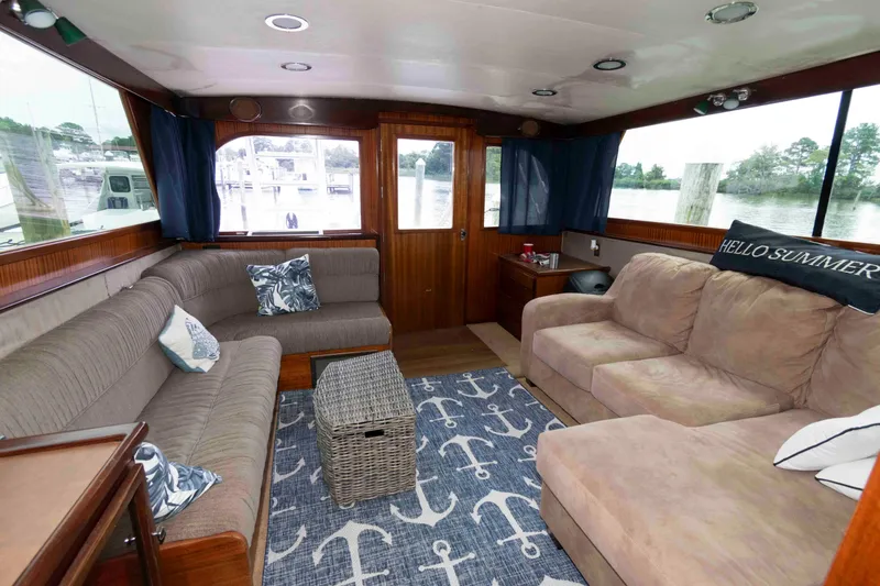 Slide: The Image of Interior of a 1970 Hatteras 45 Convertible yacht with cozy seating and nautical decor. - 14