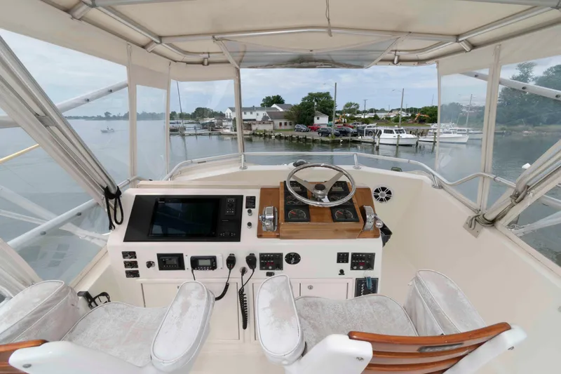 Slide: The Image of Interior view of a 1970 Hatteras 45 Convertible yacht cockpit with steering wheel and controls. - 6