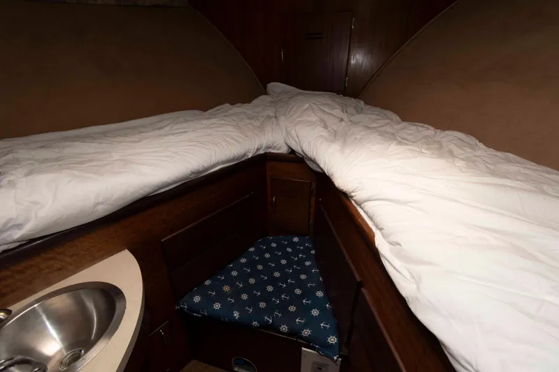 Slide: The Image of Cozy cabin interior of 1970 Hatteras 45 Convertible yacht with bedding and sink. - 19