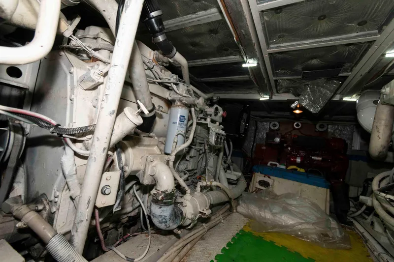 Slide: The Image of Engine room of a 1970 Hatteras 45 Convertible yacht, showcasing mechanical components. - 23