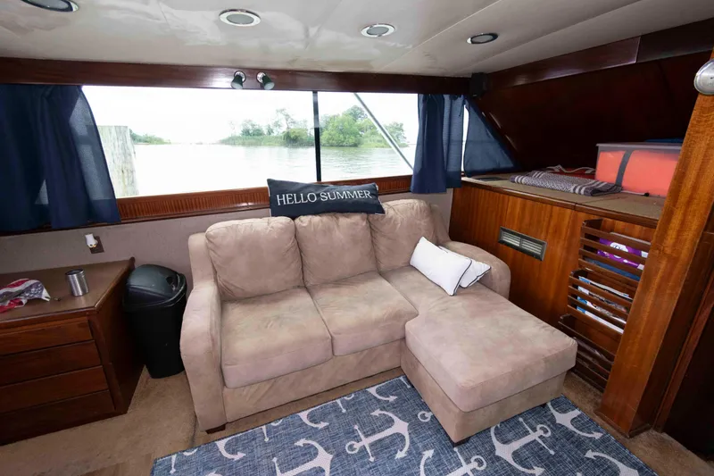 Slide: The Image of Interior of 1970 Hatteras 45 Convertible yacht with cozy seating and nautical decor. - 16