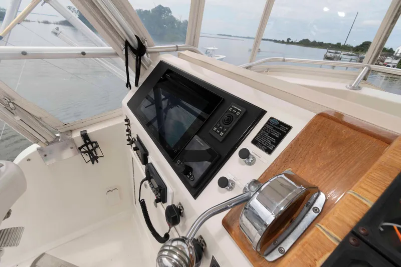 Slide: The Image of 1970 Hatteras 45 Convertible boat helm with navigation equipment and throttle controls. - 8