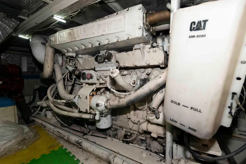 Slide: The Image of Engine room of a 1970 Hatteras 45 Convertible yacht, featuring CAT marine power components. - 22