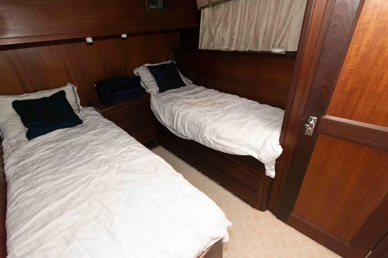 Slide: The Image of Interior cabin of 1970 Hatteras 45 Convertible with twin beds and wood paneling. - 18
