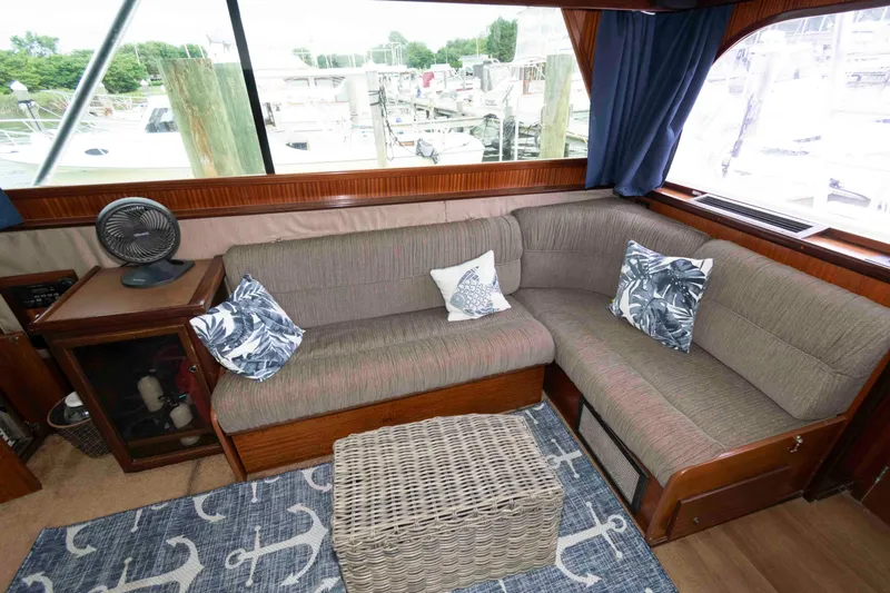 Slide: The Image of Interior of 1970 Hatteras 45 Convertible yacht with cozy seating and nautical decor. - 15