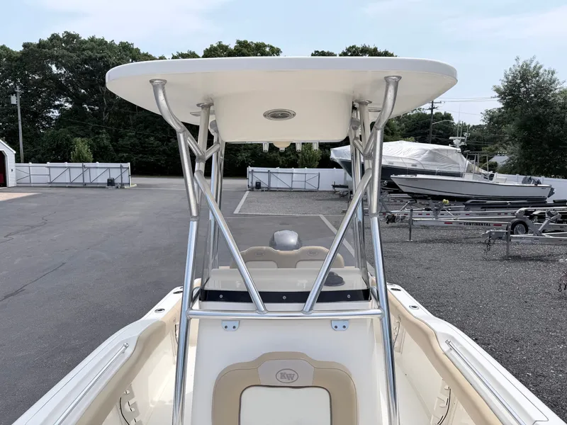 Slide: The Image of A 2014 Key West 219 FS boat with a sturdy T-top, parked on an asphalt lot. - 9