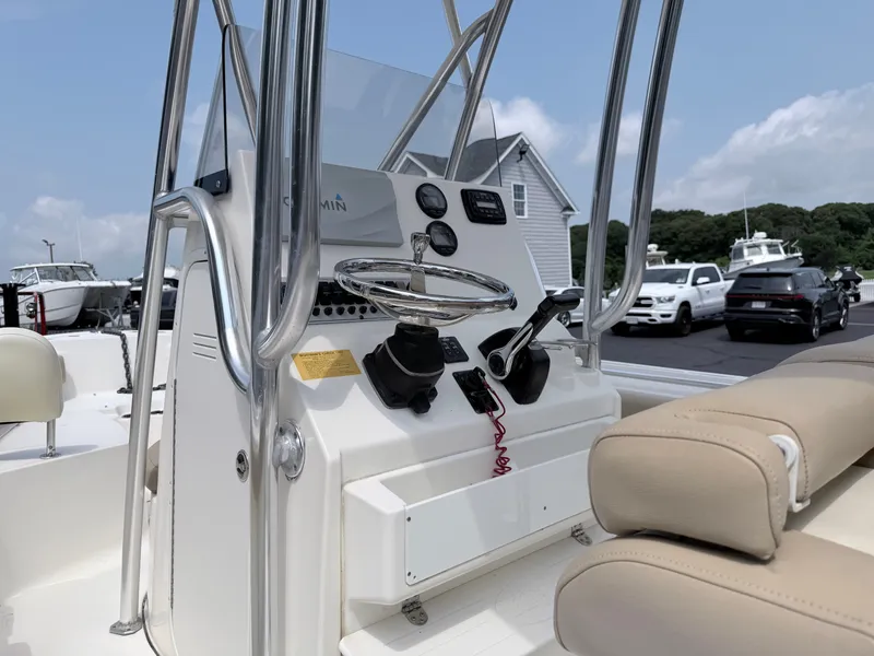 Slide: The Image of The image shows the helm of a Key West 219 FS boat with beige seating. - 14