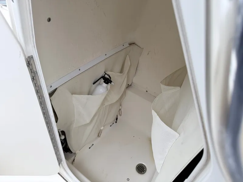 Slide: The Image of A storage compartment in the boat with pockets and a fire extinguisher. - 26